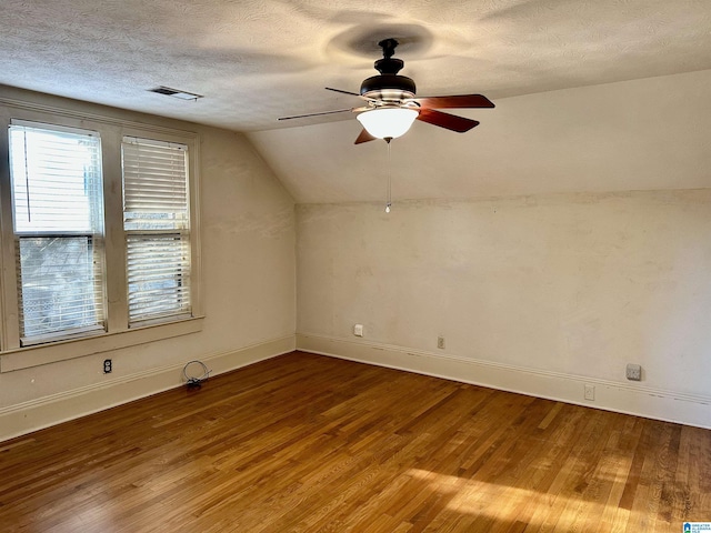 401 SW 8th St, Cullman, AL 35055 - additional living space with visible vents, vaulted ceiling, wood finished floors, a textured ceiling, and a ceiling fan
