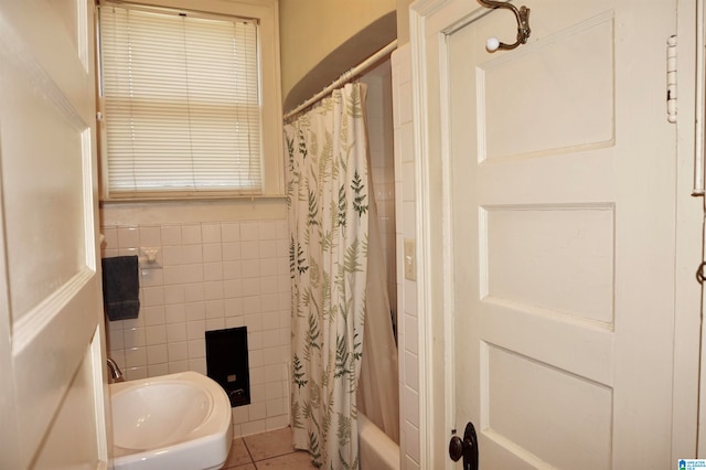 bathroom featuring shower / bath combination with curtain, tile patterned floors, and sink