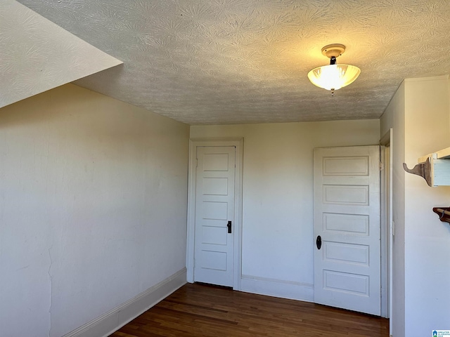 401 SW 8th St, Cullman, AL 35055 - empty room featuring dark wood-style floors, baseboards, and a textured ceiling