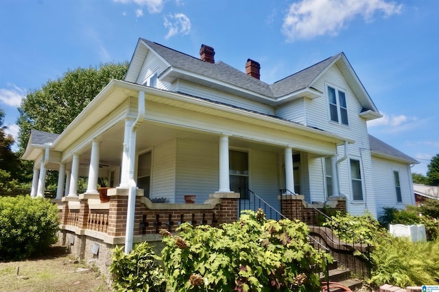401 SW 8th St, Cullman, AL 35055 - view of front of home with brick siding, covered porch, and a chimney