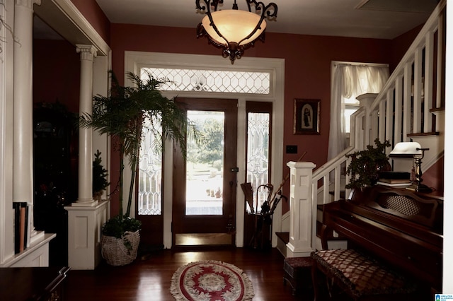 entrance foyer featuring ornate columns and dark hardwood / wood-style floors