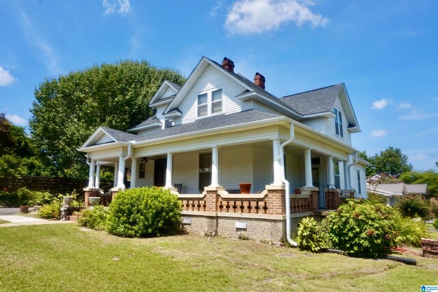 view of home's exterior featuring covered porch and a yard