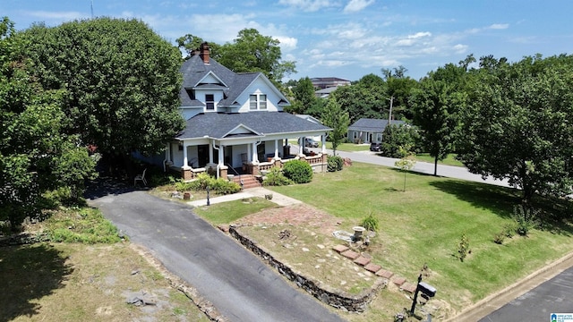 401 SW 8th St, Cullman, AL 35055 - view of front of property featuring driveway, roof with shingles, covered porch, and a front lawn