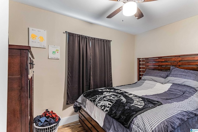 bedroom with a ceiling fan and wood finished floors