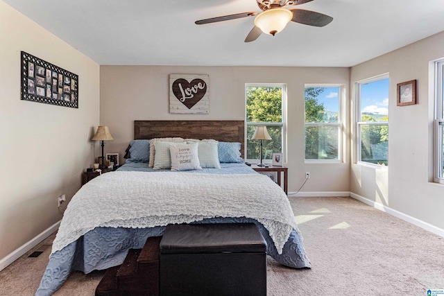 carpeted bedroom featuring ceiling fan and baseboards