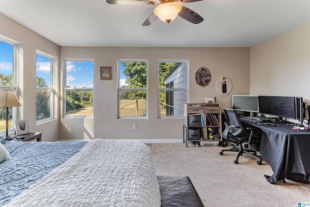 bedroom featuring ceiling fan, baseboards, and carpet flooring