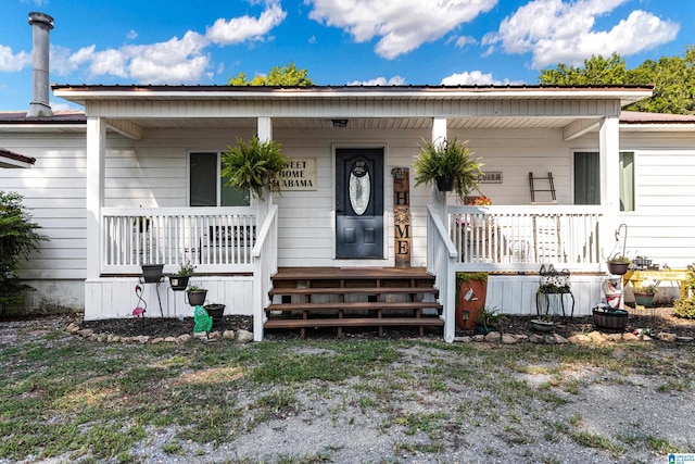 view of front of property with covered porch and metal roof