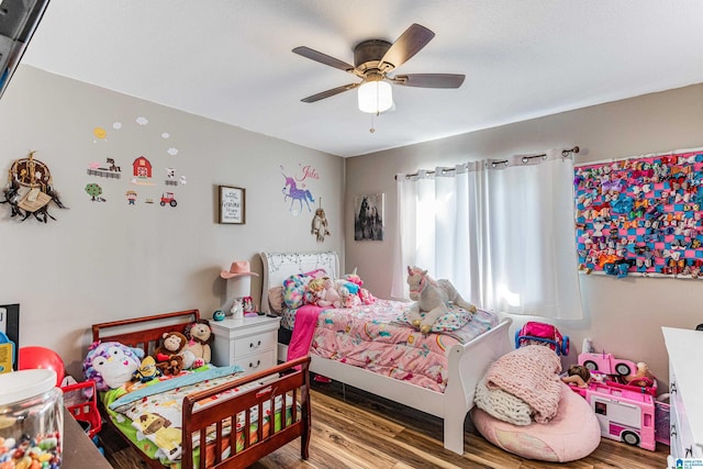 bedroom with a ceiling fan and wood finished floors