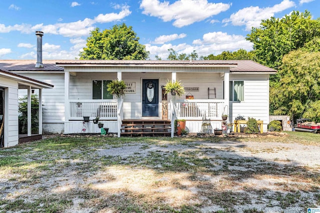 view of front of property featuring a porch and metal roof