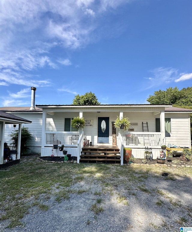 view of front of property with covered porch and metal roof