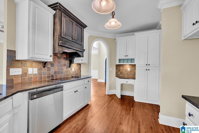 kitchen featuring crown molding, decorative backsplash, dishwasher, white cabinetry, and hardwood / wood-style flooring