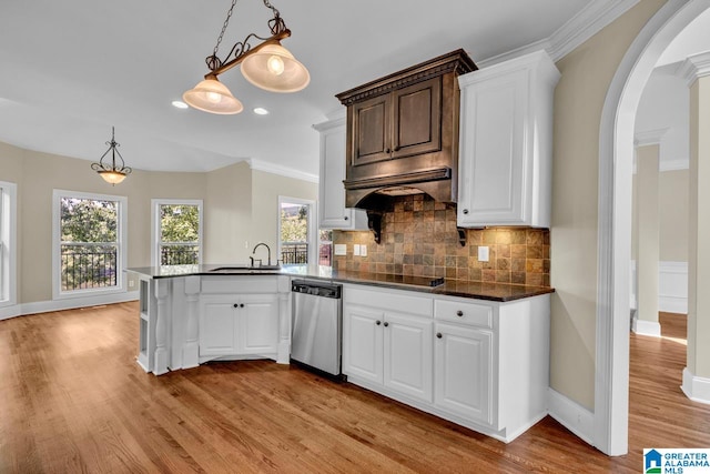 kitchen featuring pendant lighting, dishwasher, light hardwood / wood-style floors, decorative backsplash, and kitchen peninsula