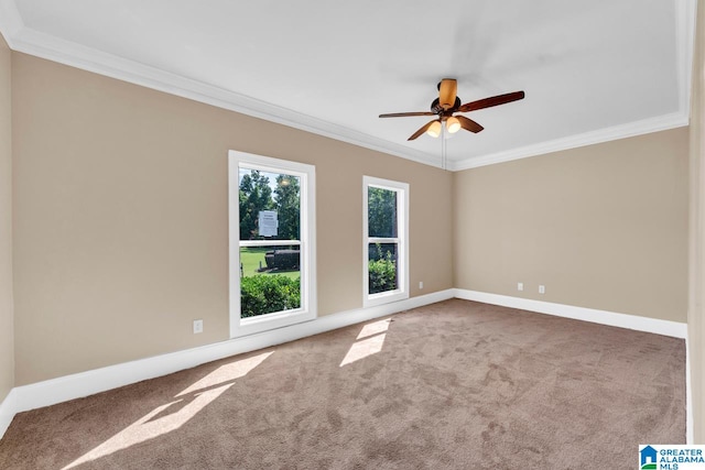 carpeted empty room featuring ceiling fan and crown molding