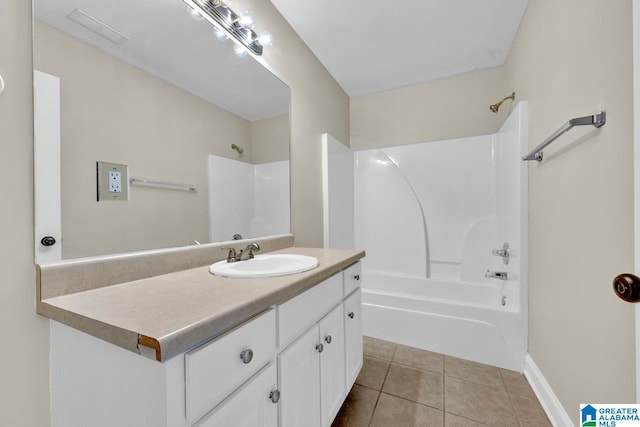 bathroom with tub / shower combination, tile patterned floors, and vanity