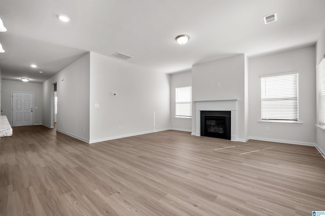 unfurnished living room featuring light hardwood / wood-style floors