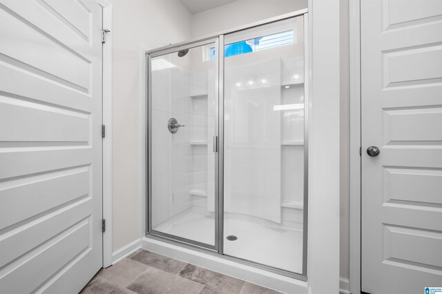 bathroom with a shower with door