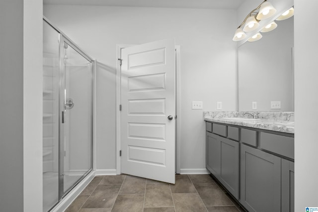 bathroom with walk in shower, vanity, and tile patterned flooring