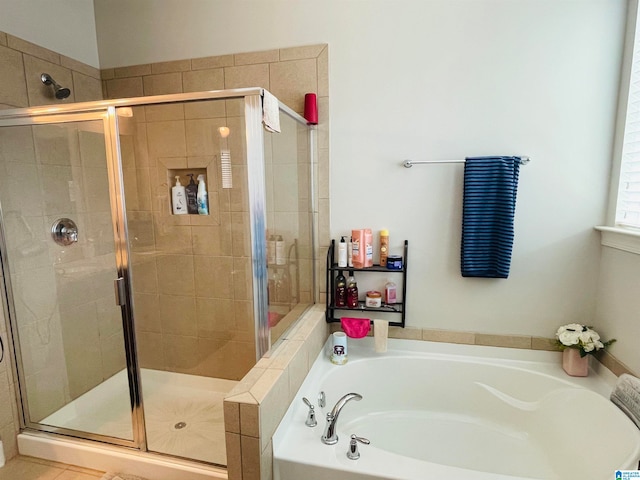 bathroom featuring independent shower and bath