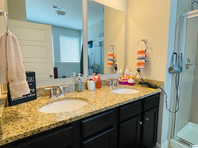 bathroom featuring walk in shower and vanity