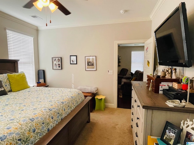 bedroom with ceiling fan, ornamental molding, and light carpet