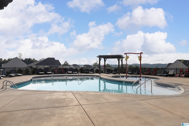 view of swimming pool featuring a pergola and a patio area