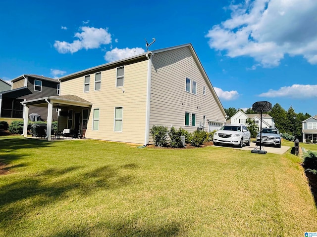 view of side of property featuring a garage and a lawn