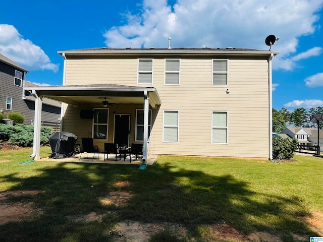 rear view of property with ceiling fan, a yard, and a patio