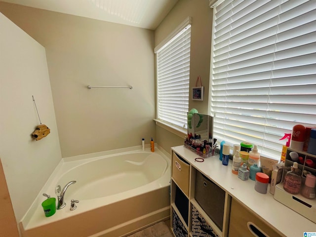 bathroom with a washtub and vanity