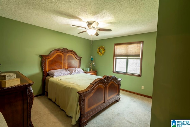 bedroom with ceiling fan, a textured ceiling, and light carpet