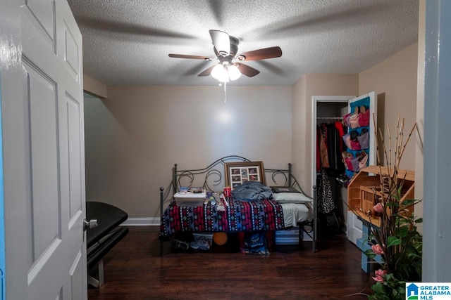 bedroom with a closet, dark hardwood / wood-style flooring, a textured ceiling, and ceiling fan