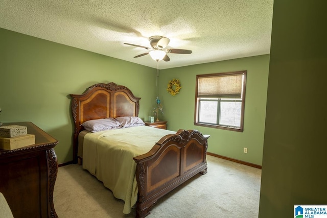 bedroom with a ceiling fan, light colored carpet, a textured ceiling, and baseboards