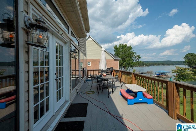 wooden deck with a water view