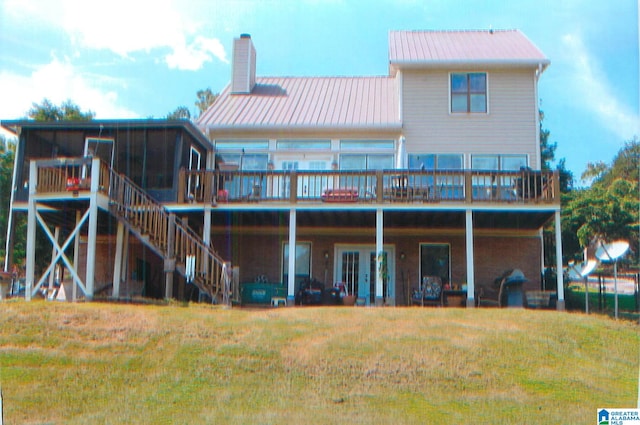 rear view of house featuring a yard and a wooden deck