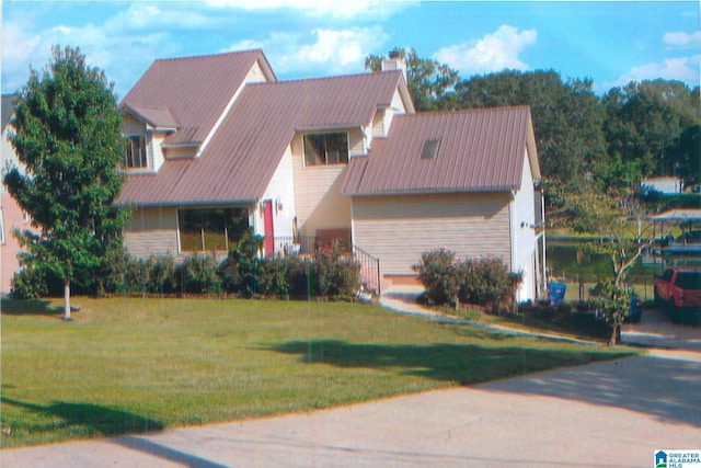 view of front of home with a front lawn and a chimney