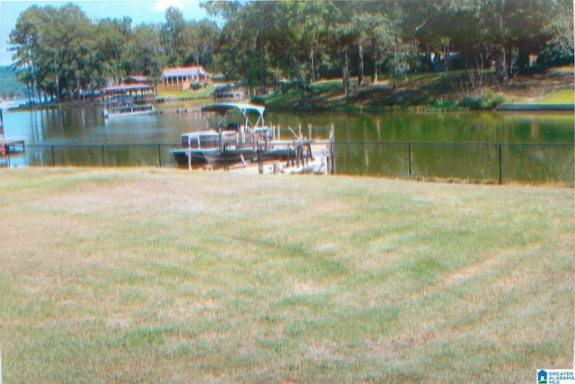 dock area featuring a yard and a water view