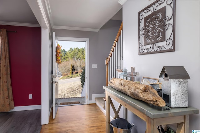 entrance foyer with ornamental molding and wood-type flooring