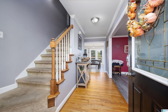 entrance foyer with crown molding and light wood-type flooring