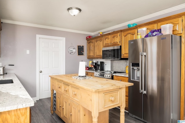 kitchen with wood counters, decorative backsplash, ornamental molding, and stainless steel appliances