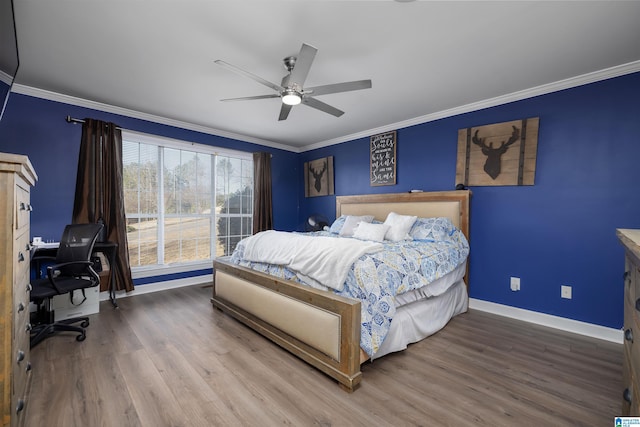 bedroom featuring crown molding, hardwood / wood-style floors, and ceiling fan