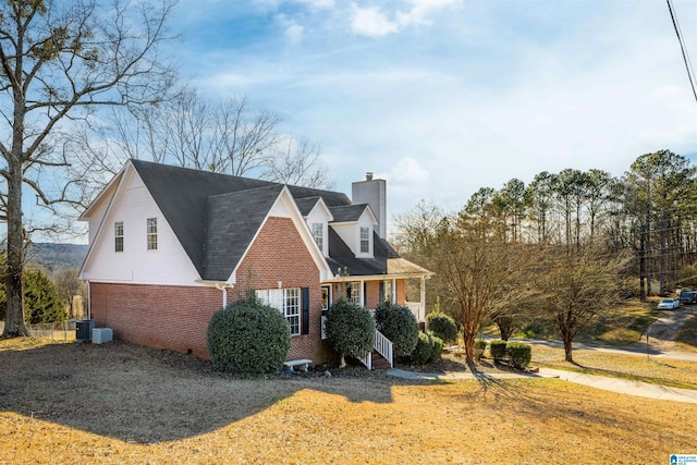 view of side of property with central air condition unit and covered porch