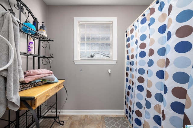 interior space with a shower with shower curtain