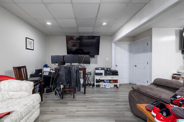 office area with a paneled ceiling and light hardwood / wood-style floors