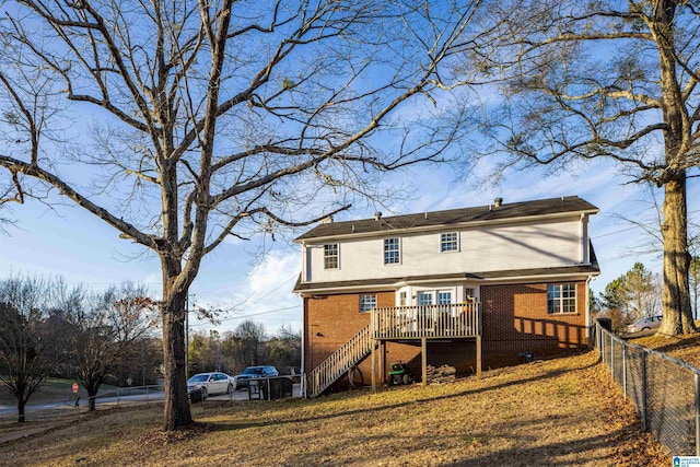 back of house with a wooden deck