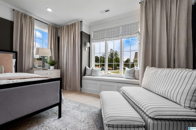 bedroom with light hardwood / wood-style floors and crown molding