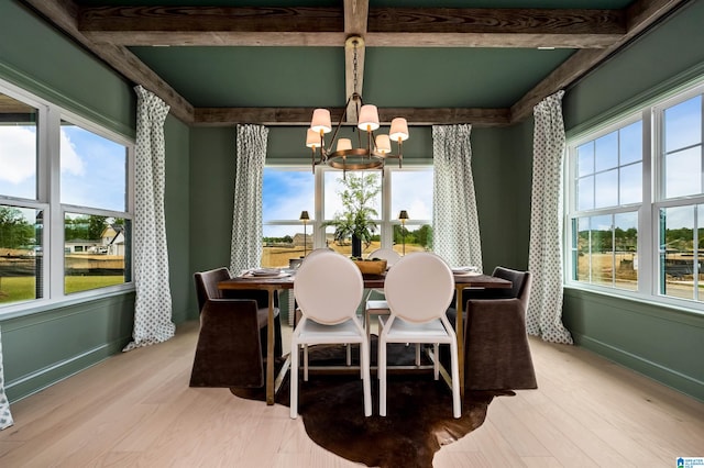 dining space featuring beamed ceiling, light wood-type flooring, and a chandelier