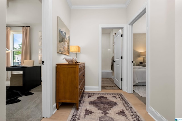 hall featuring ornamental molding and light carpet