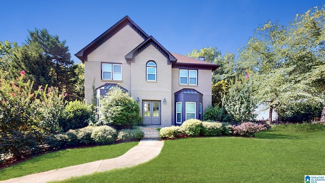 view of front of property featuring a front yard and brick siding