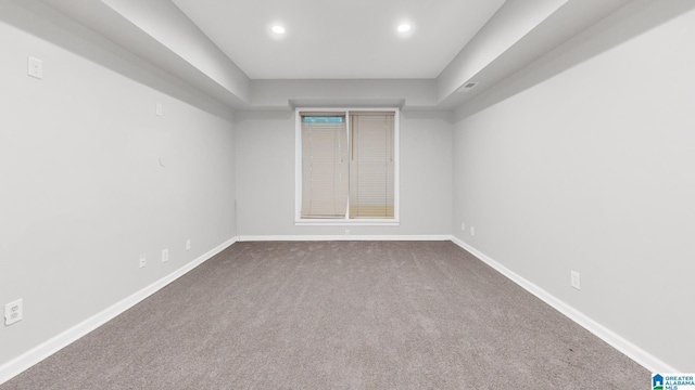 unfurnished room featuring dark colored carpet, recessed lighting, visible vents, and baseboards