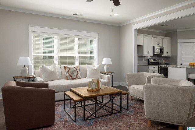 living room featuring ceiling fan, dark hardwood / wood-style floors, and crown molding