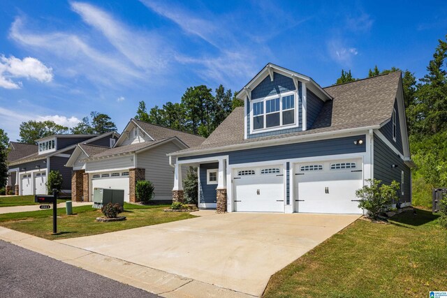 craftsman-style home featuring a front yard and a garage